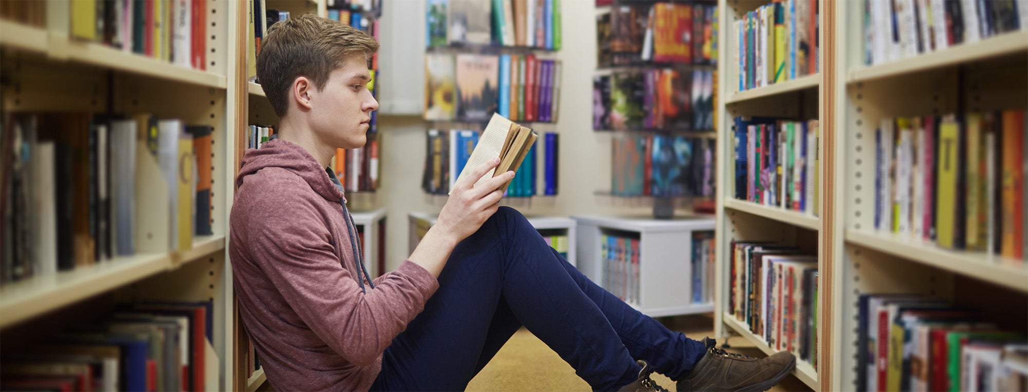 Photo of student reading in library