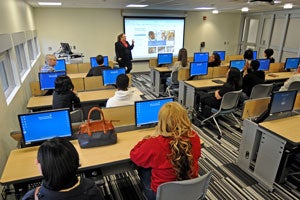 Students sitting in a classroom listening to instructor.