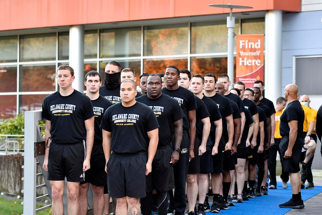 Cadets from the College’s Municipal Police Academy stand at attention in front of the STEM Center on the Marple Campus in preparation for their final training run.