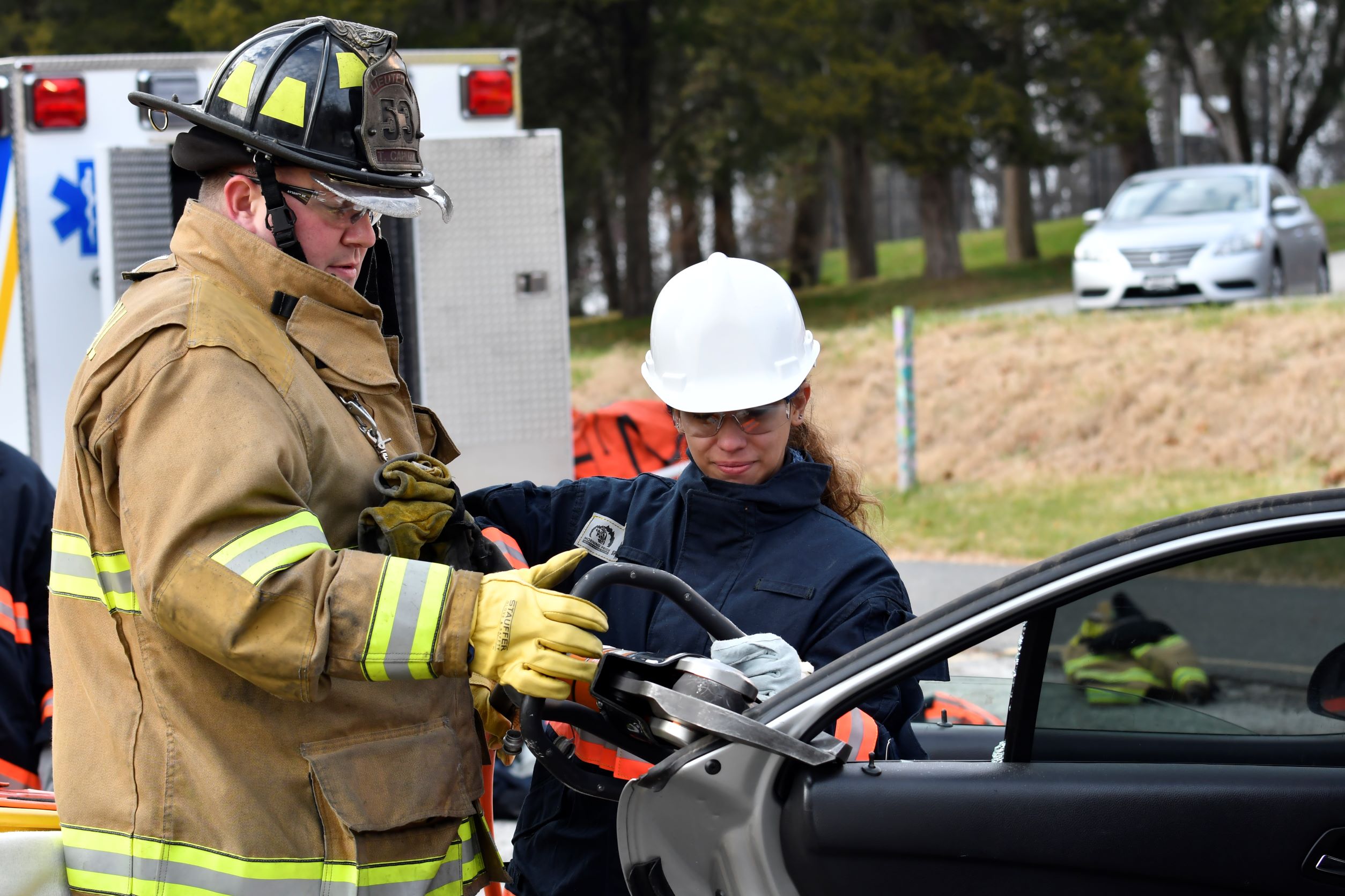 College Paramedic Coordinator/Broomall Fire Company Lieutenant Tim Capuzzi shows EMS-100 student Alexea Patton of Norwood how to use a hydraulic extrication rescue tool