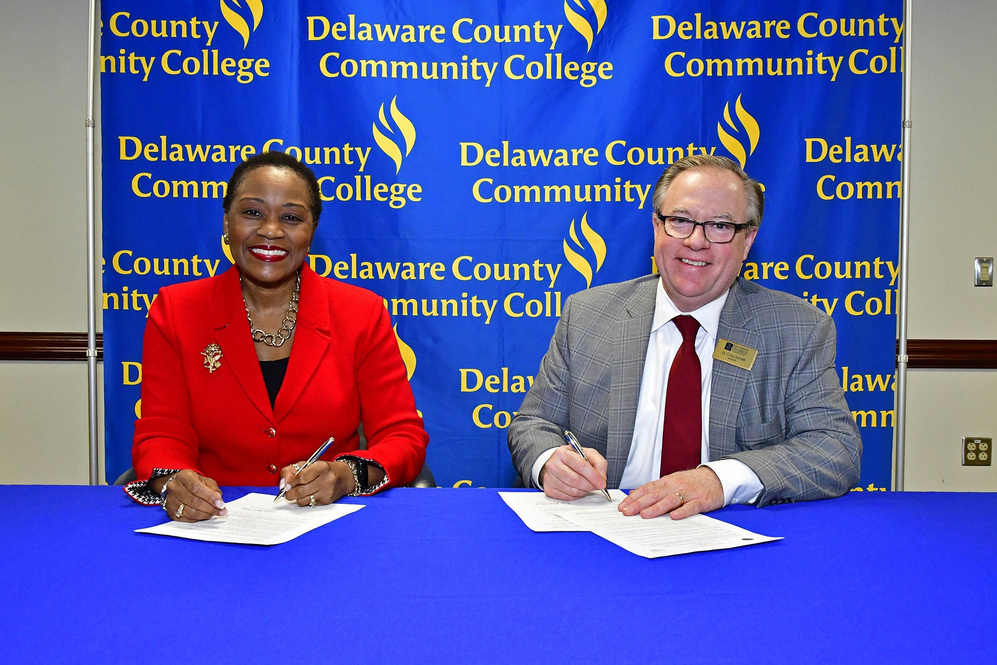 Delaware County Community College President Dr. L. Joy Gates Black and Neumann University President Dr. Chris Domes sign a new agreement that will benefit Neumann University criminal justice majors