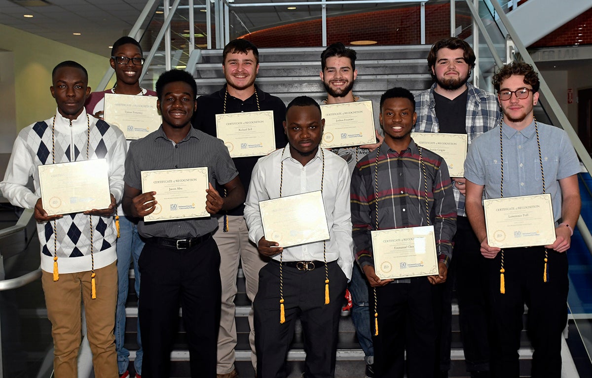 Holding certificates of completion from the Dual Enrollment Early College Electro-Mechanical Technologies program are front row, left to right: Raymond Kamara, Jason Abu, Albert Koroma, Emmanuel Chea and Lawarence Poff; back row, left to right: Tyrese Pettaway, Richard Bell, Joshua Fournier and Austin Coigne. Not shown is Shawn Flynn