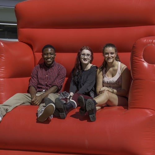 students on a gaint chair at 2015 Fall Open House