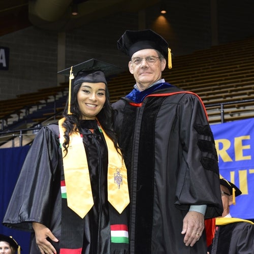 President Jerry Parker poses with grad