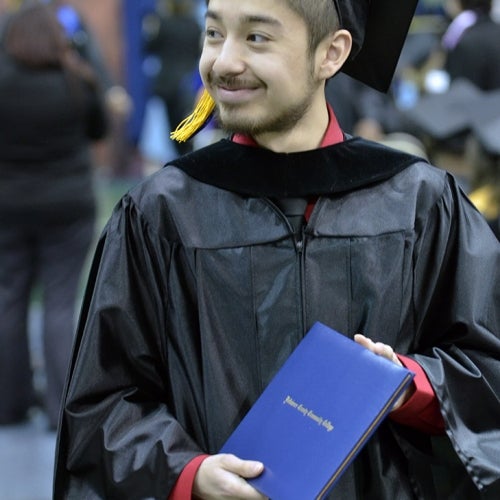 Graduate holds diploma