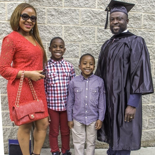 Graduate poses with family