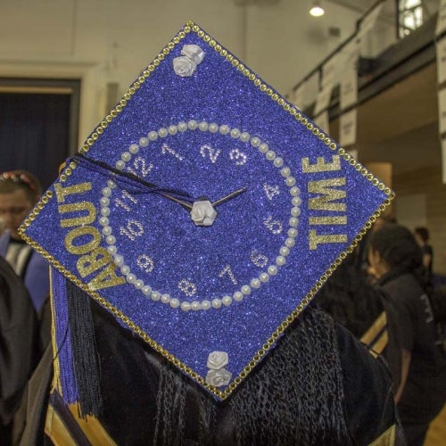 Customized student cap with words, "About time"