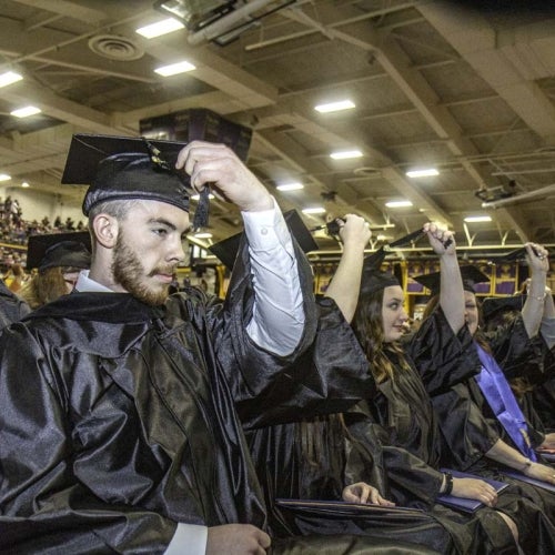 Grads move tassles on caps at end of ceremony
