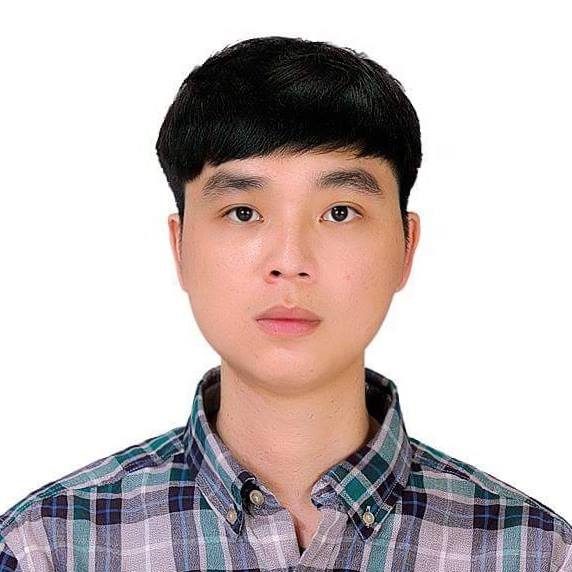 Portrait of a person wearing a checkered shirt with a neutral expression, set against a plain white background.