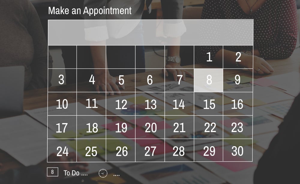 Interactive calendar interface titled 'Make an Appointment,' displaying a monthly calendar view with highlighted dates for scheduling, with blurred background showing people collaborating over documents.