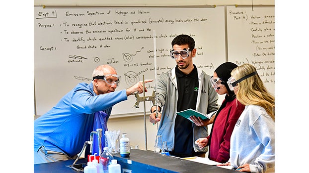 Chemistry Professor working with three students