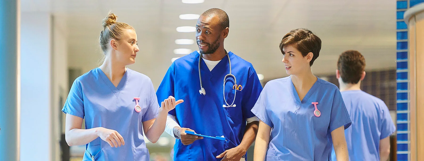 stock image of health care professionals talking in hallway