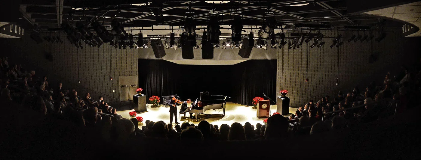 A band performing on stage in front of an audience.