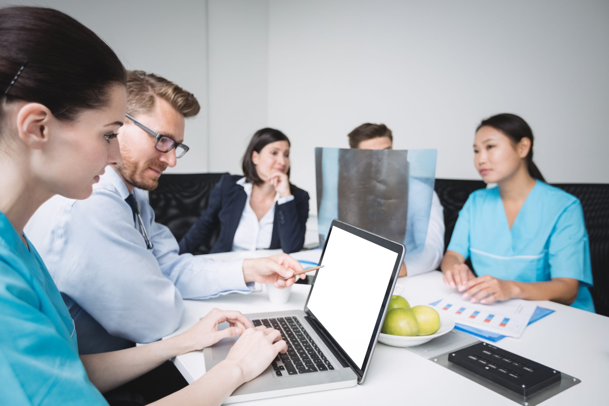 Medical team discussing laptop data