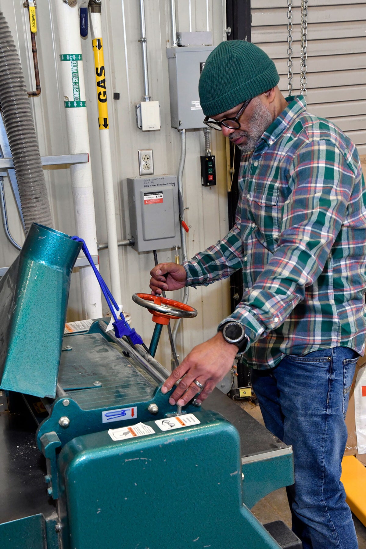 Student operating carpentry equipment