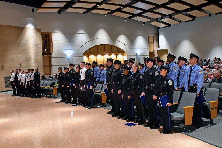 Police academy graduates standing at ceremony