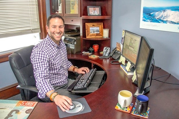 Michael Monastra, paralegal student, sitting at desk