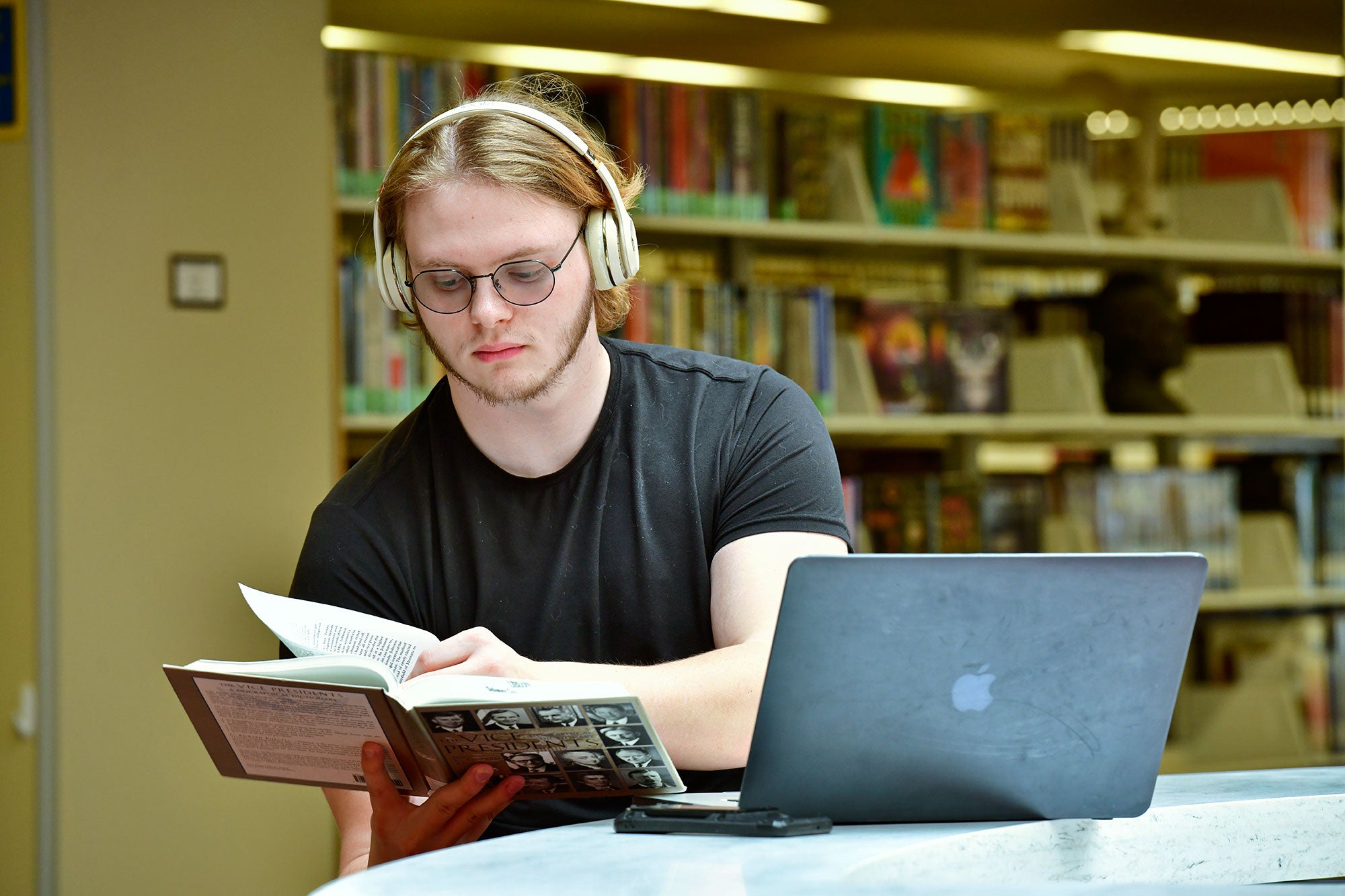 Male student working at laptop computer