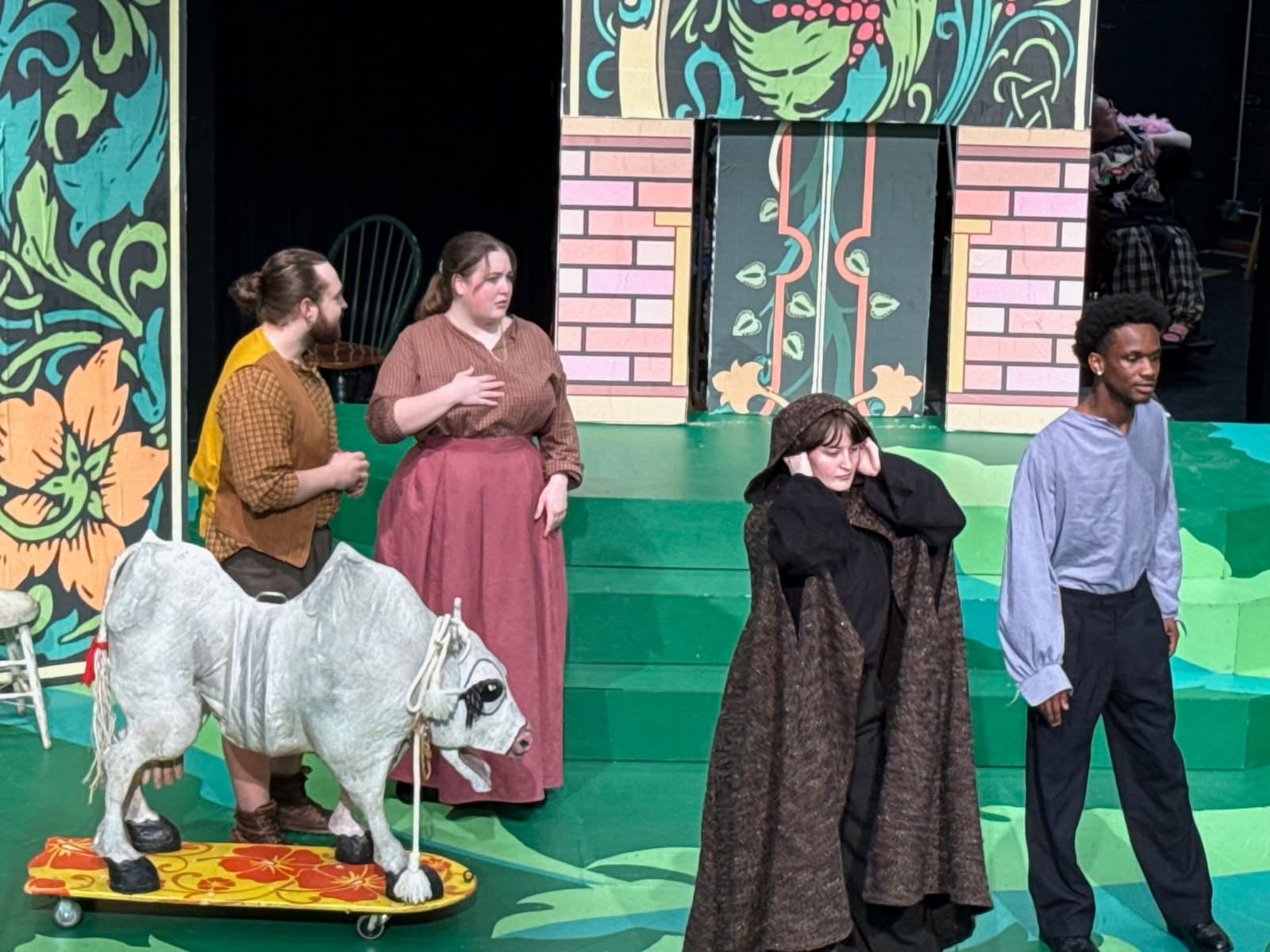 Actors perform fairy tale scene on colorful stage
