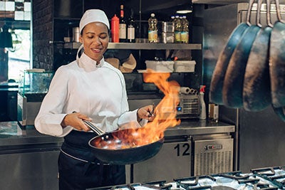 Female chef, working in commercial kitchen