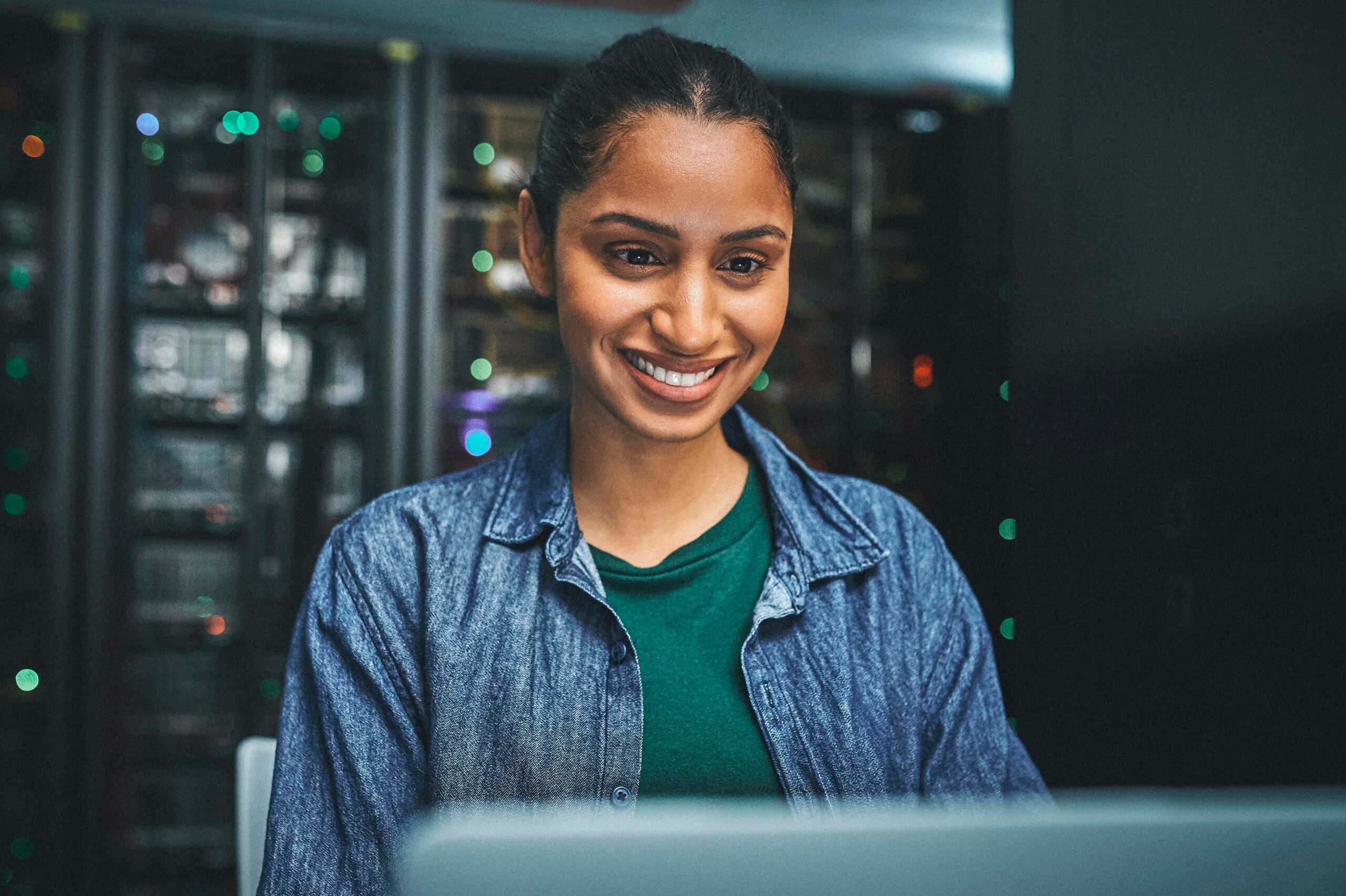 Female student smiling at computer