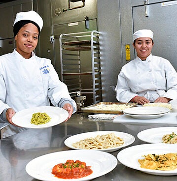 culinary arts students showing finished dishes