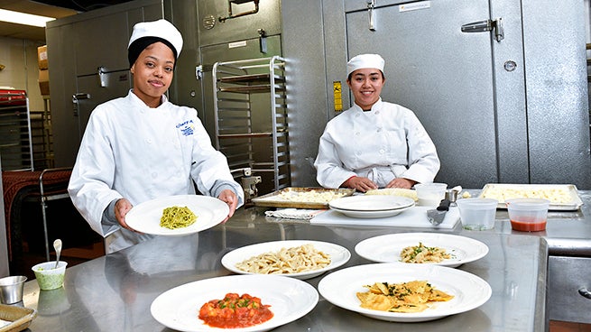 culinary arts students showing finished dishes