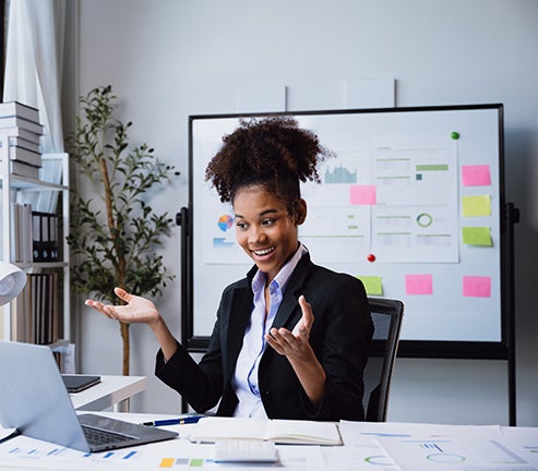 business woman sitting at computer and smiling