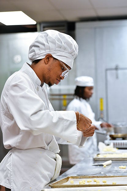 Culinary Arts student working on a dish