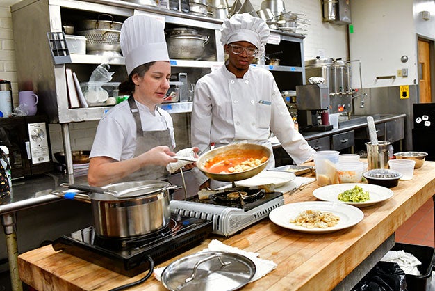 Culinary Arts professor working with student