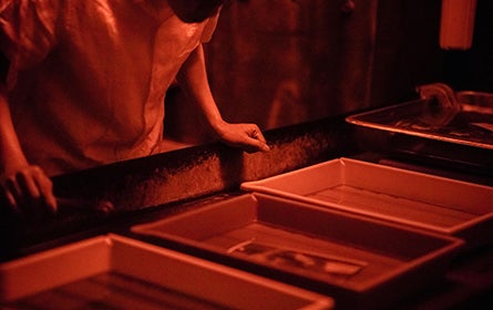 Photography student in dark room
