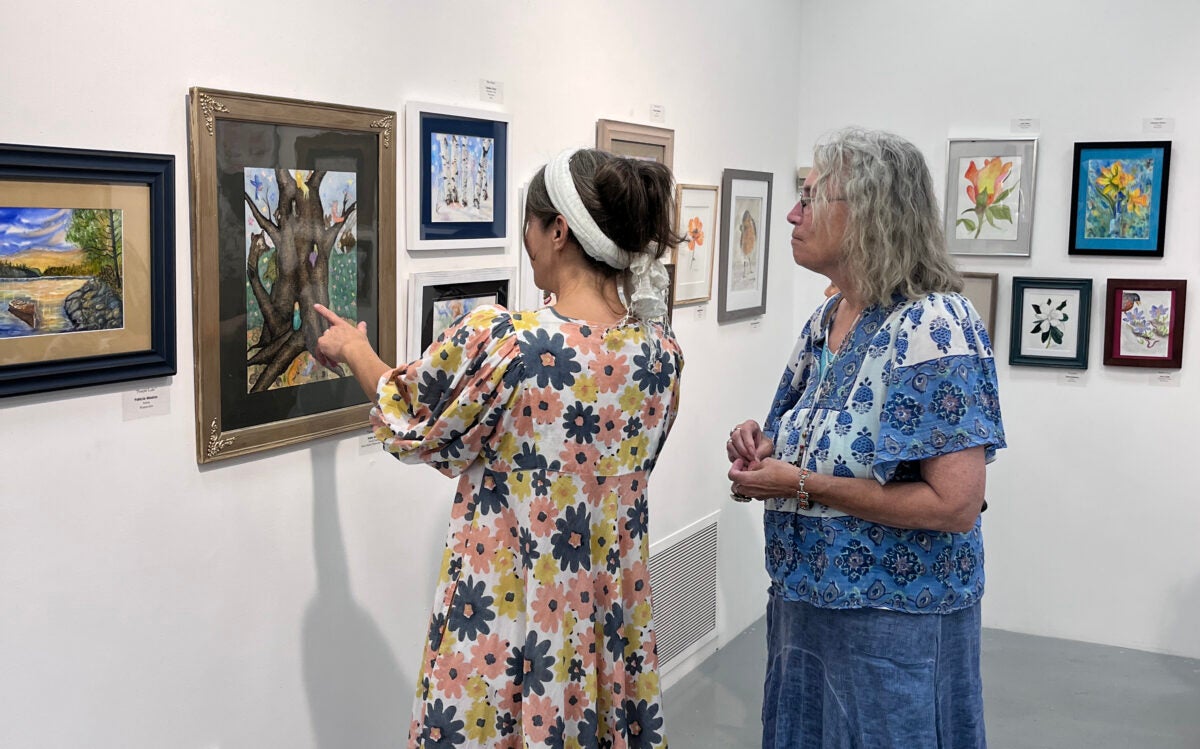 Gallery-goers view artwork at DCCC's art gallery.