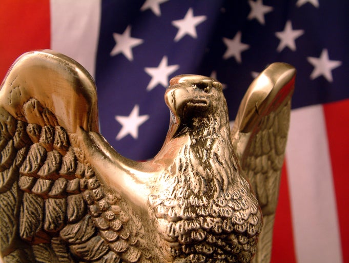 Golden eagle statue with American Flag in background
