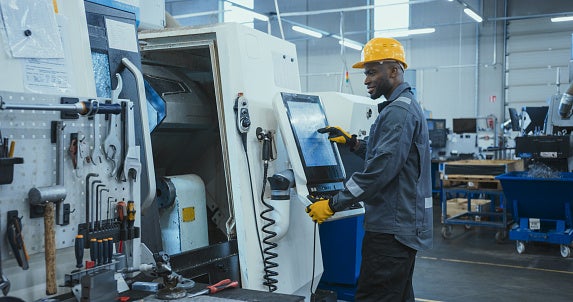 Male student working at advanced manufacturing computer monitor