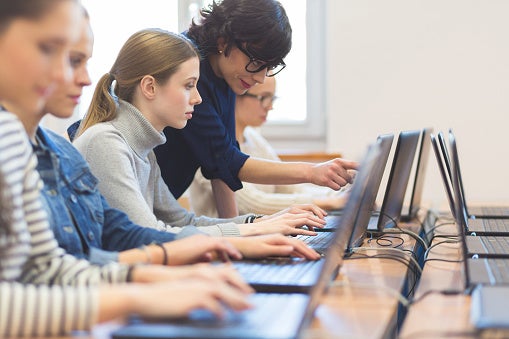 Students looking at computer monitor together
