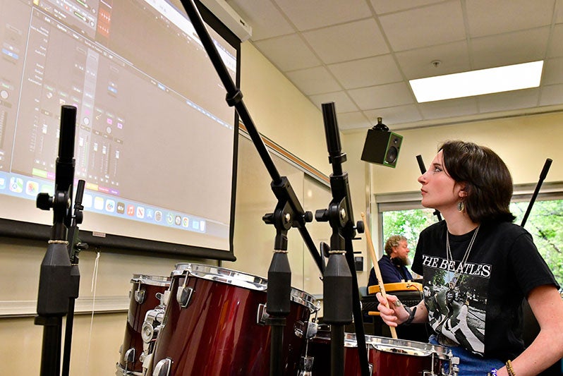 Student at drumset in music class